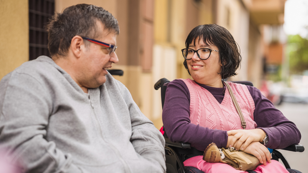 People with disability having conversation on street